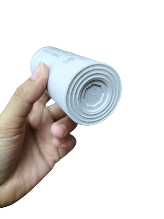 25MFD Running Capacitor 450V held in hand, showcasing its cylindrical white design for electrical applications