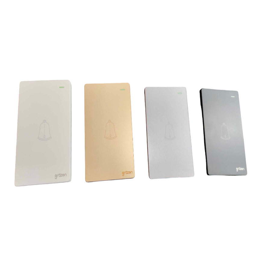 Four rectangular smart wall panels in white, champagne gold, silver, and dark gray, arranged in a row on a plain white background. Each panel features a minimalist bell icon in the center and the 'grtan' brand logo at the bottom.