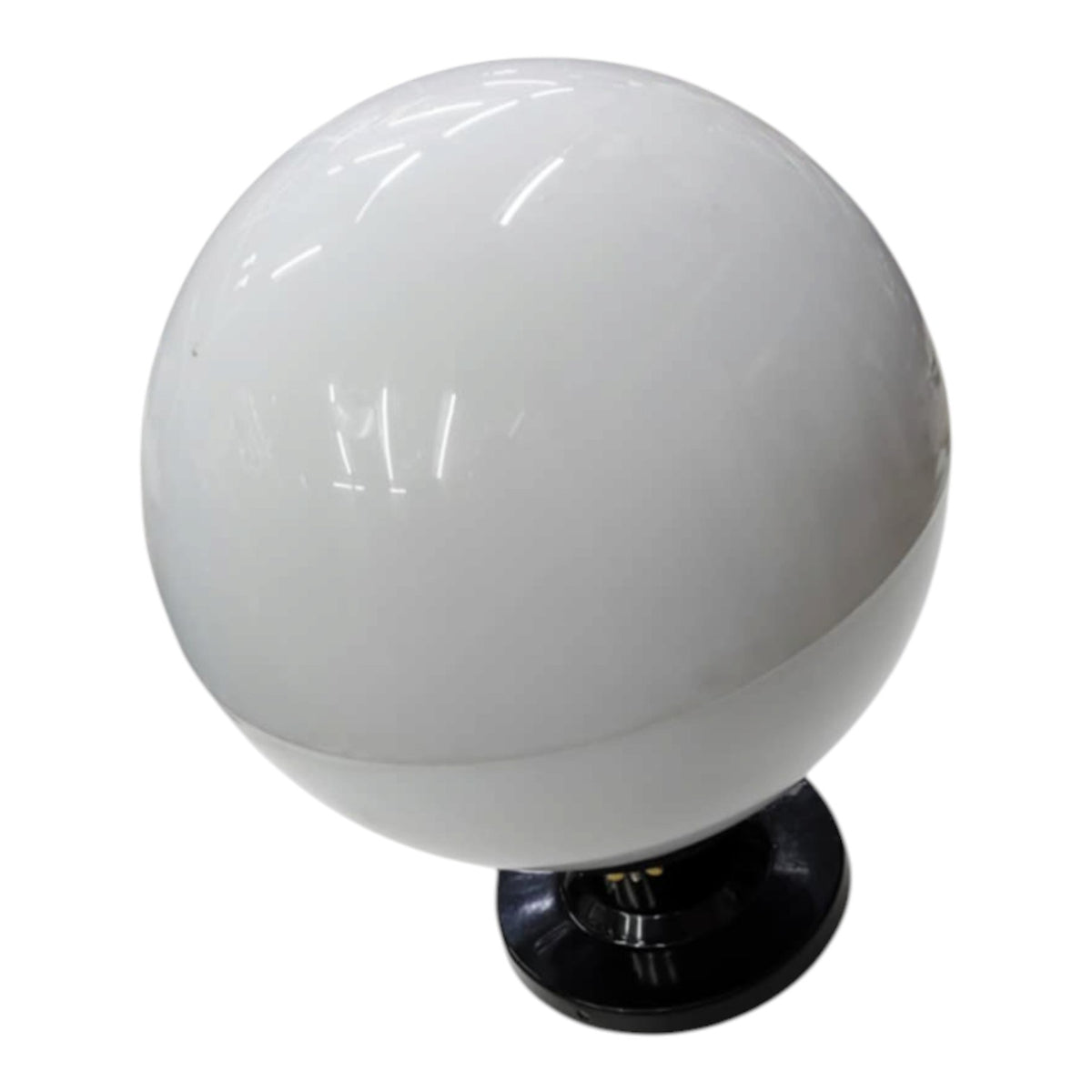 A white spherical globe lamp or light fixture with a glossy finish, mounted on a black circular base against a plain white background.