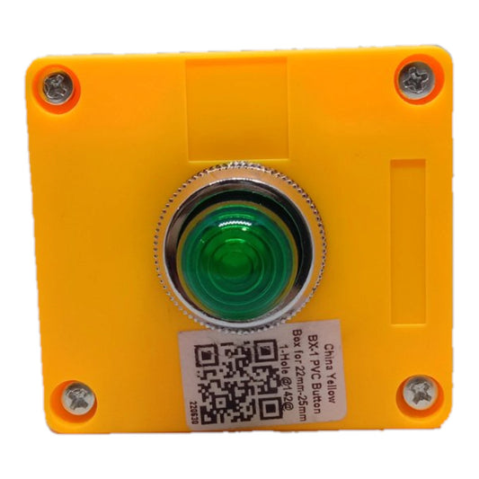 A square yellow plastic push button enclosure with a central green push-button and a silver metal bezel, shown on a white background with a product label sticker.