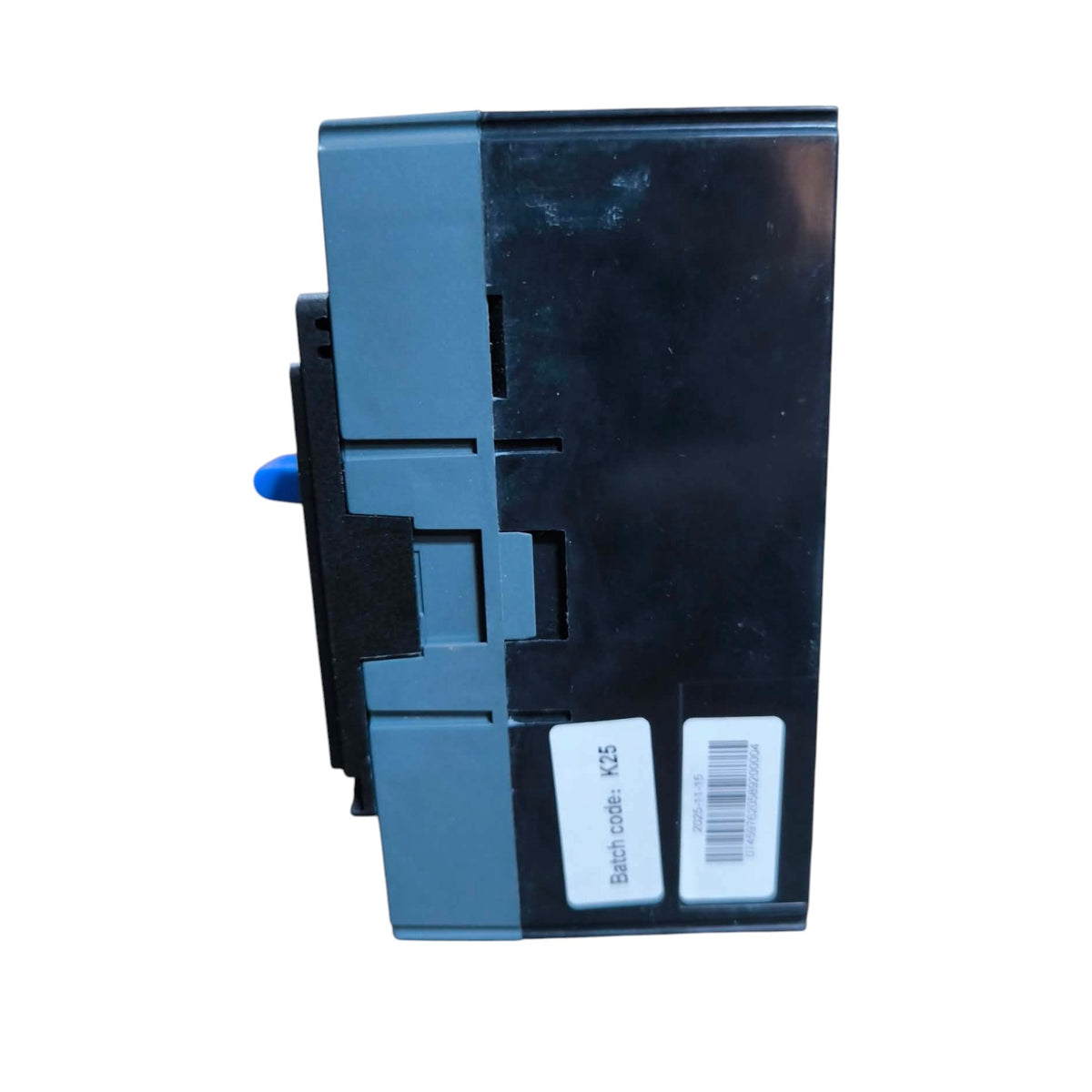 A black and gray industrial electrical component or module with a small blue protruding tab and two white labels, shown on a plain white background.
