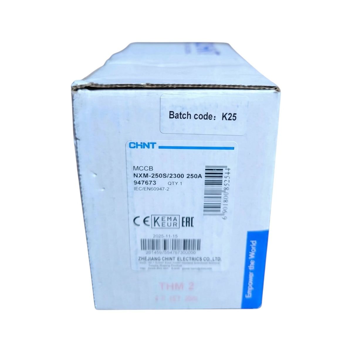 A white cardboard box with blue printed text and barcodes, showing CHNT branding and product details including MCCB NXM-250S/2300 250A and batch code K25, on a plain white background.