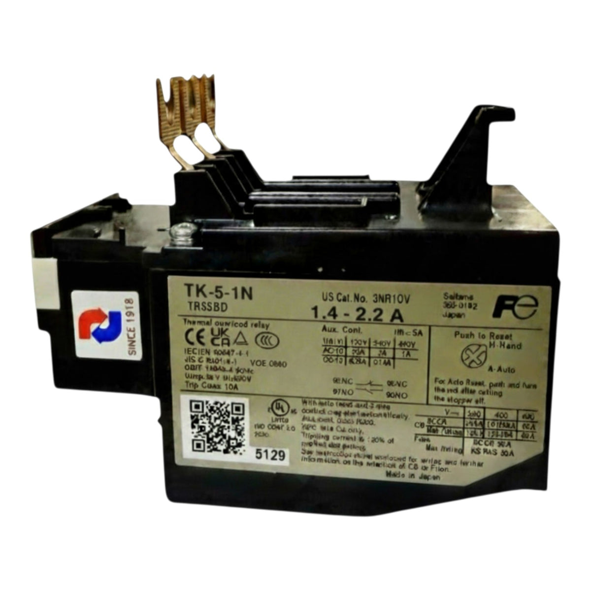 A black industrial electrical relay component with a beige technical specification label, featuring two gold-colored metal terminal posts on top, photographed on a white background.