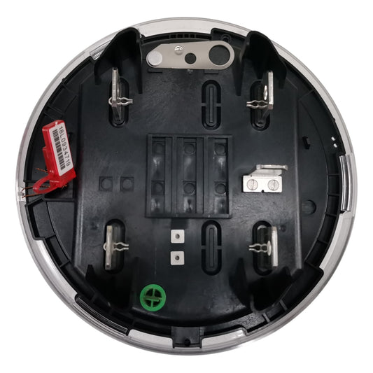 Close-up of a round electronic component with visible wiring and connectors on a white background