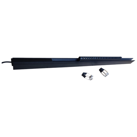 Long black rectangular object with two small cylindrical items on a white background