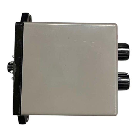 A square electronic control box with a beige-gray plastic casing, black mounting brackets on the sides, and two black rotary knobs on the right side.