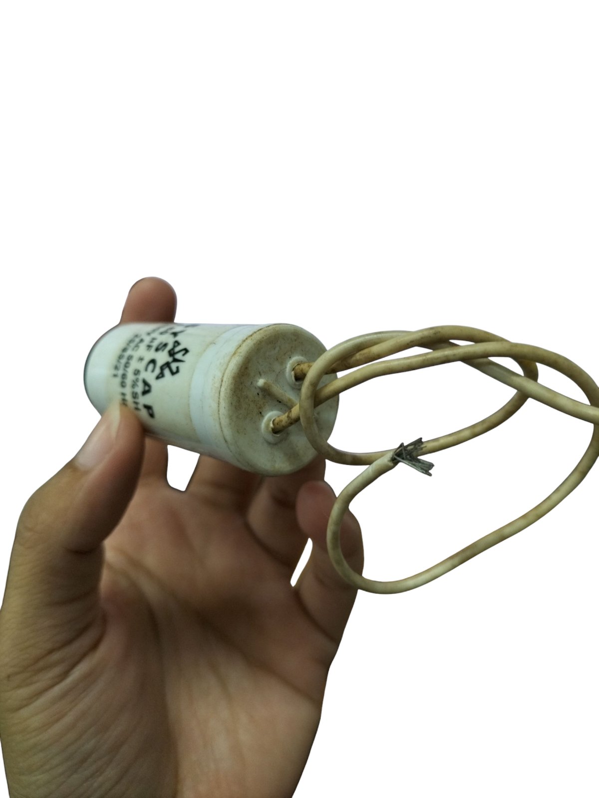 Hand holding a SYSCAP motor capacitor 4.8MFD with attached wires for electrical circuitry