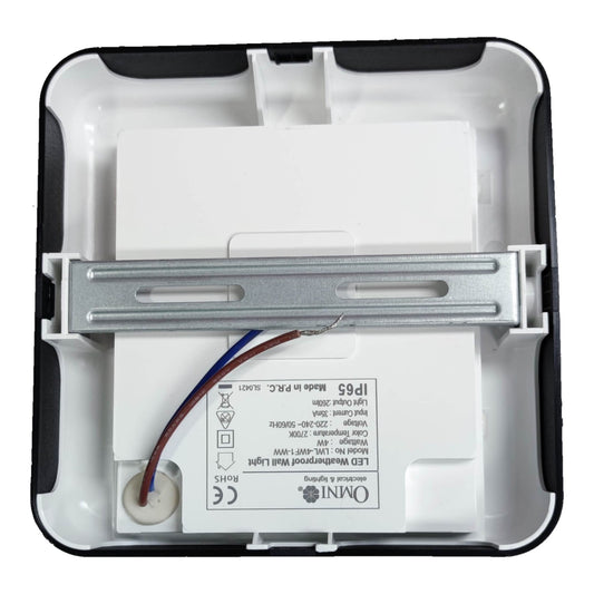 The back side of a square white and black outdoor LED wall light housing, showing the internal metal mounting bracket, wiring, and printed specifications including the Omini brand logo.