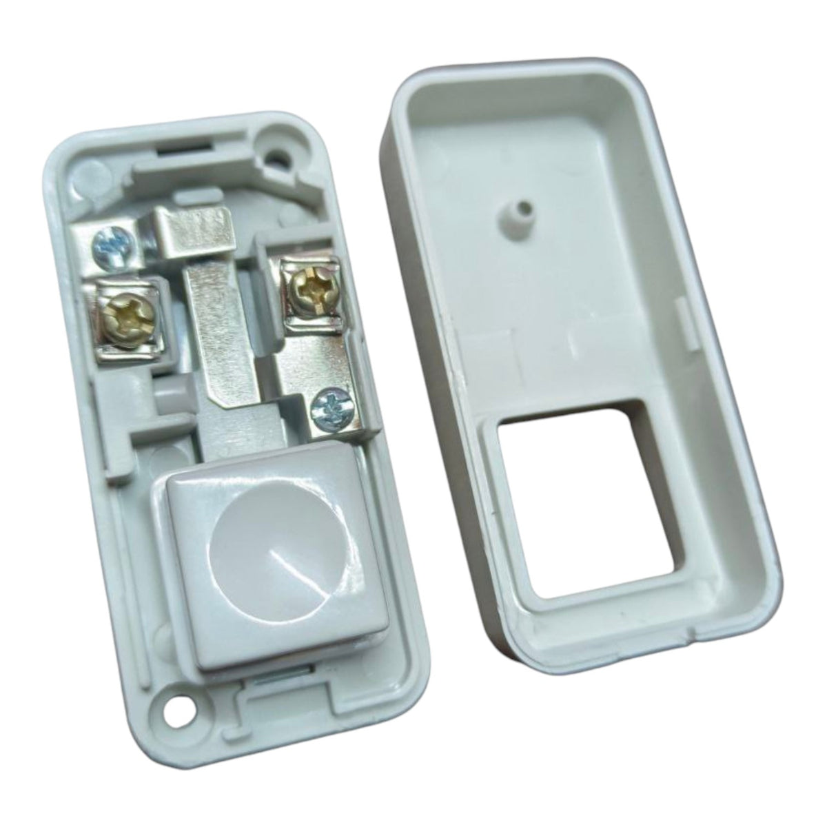 A white plastic electrical switch component shown open, with the inner base and outer cover placed side by side on a plain white background.