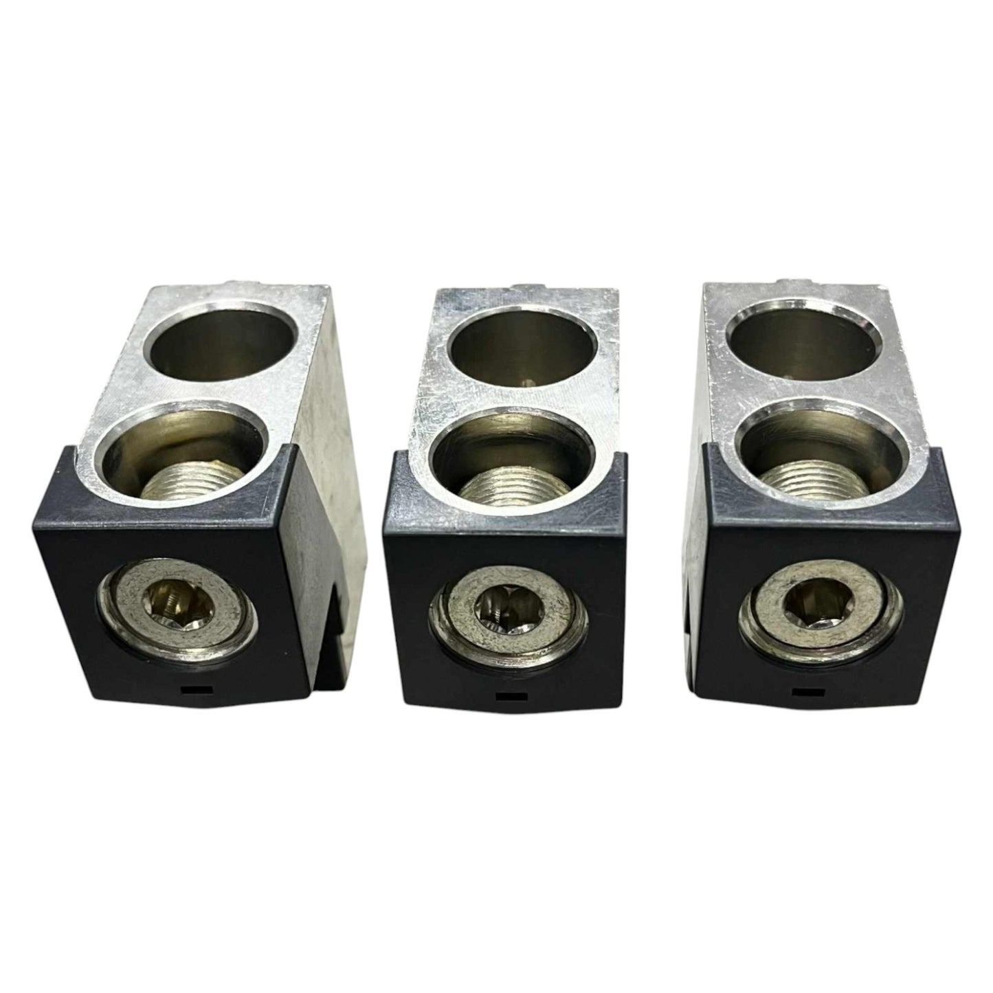 Three metallic block components with threaded holes on a white background