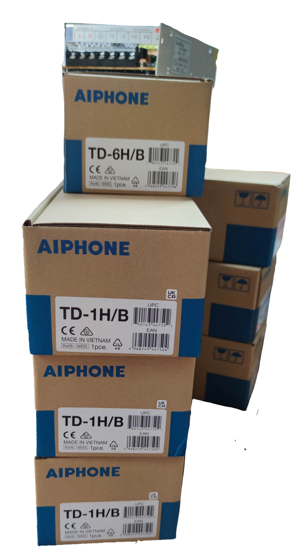 Stacked Aiphone boxes containing components for Aiphone 6 station intercom system CCTV and security system
