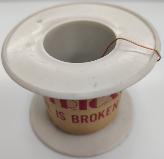 Philflex spool of AWG 43 magnet wire with thin copper wire on white plastic spool