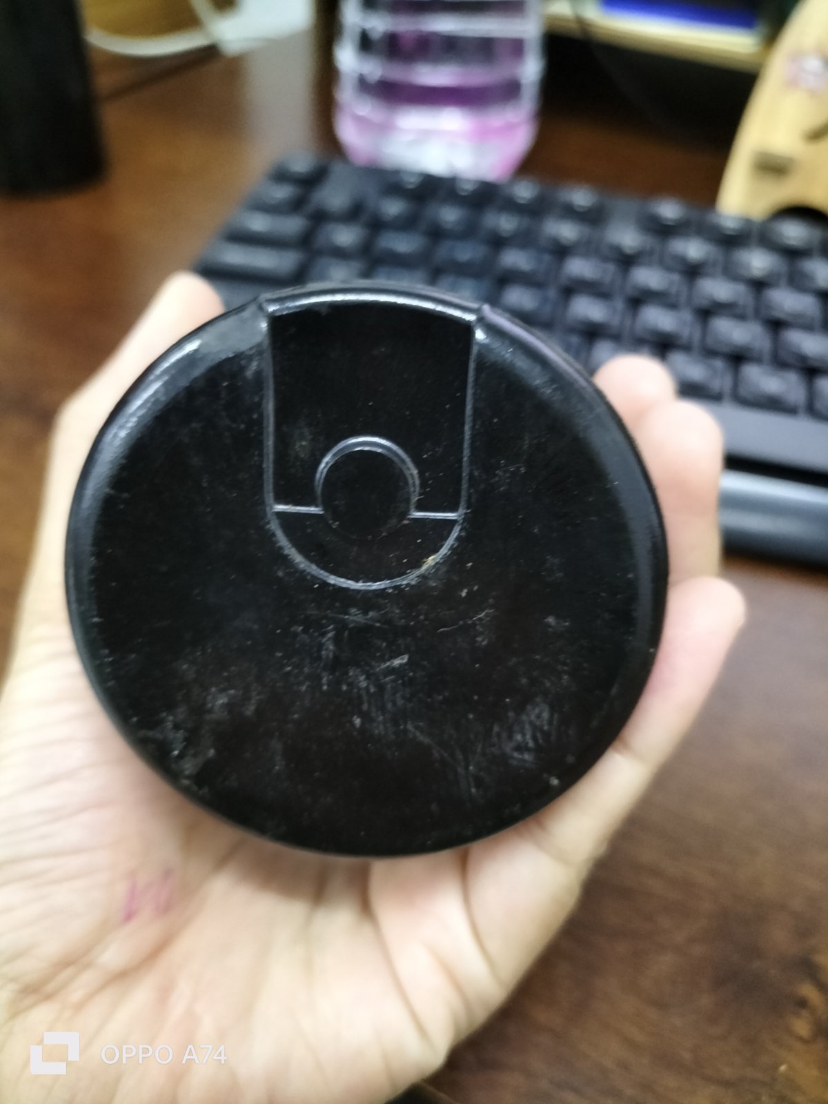 BMI 378-454UF starting capacitor black round electrical component held in hand