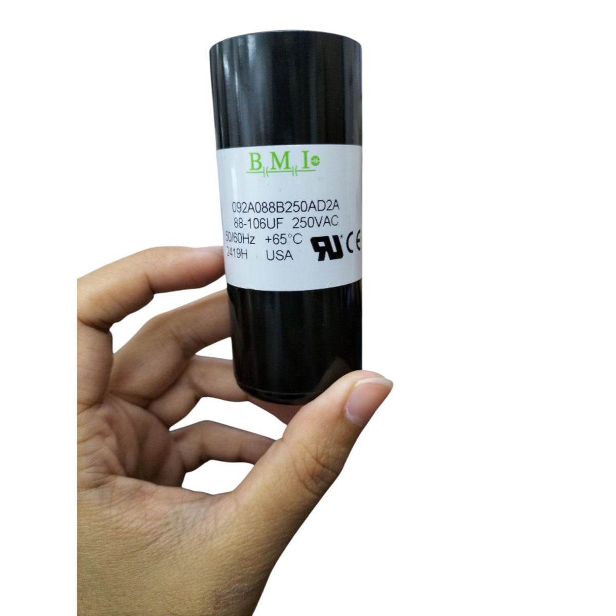 BMI 88-106MFD 250V AC capacitor in a hand, designed for electrical applications