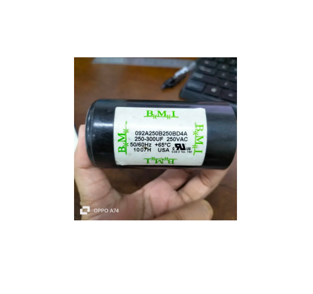 BMI motor starting capacitor 250-300 uf black cylindrical electrical part held in hand