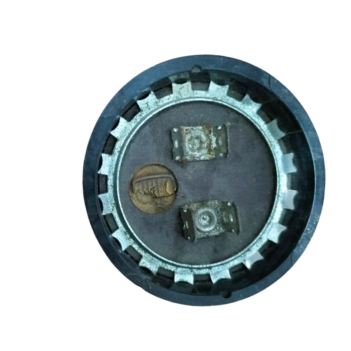 BMI Starting Capacitor 18-22UF 250V round housing top view with two metal terminals and mounting screw