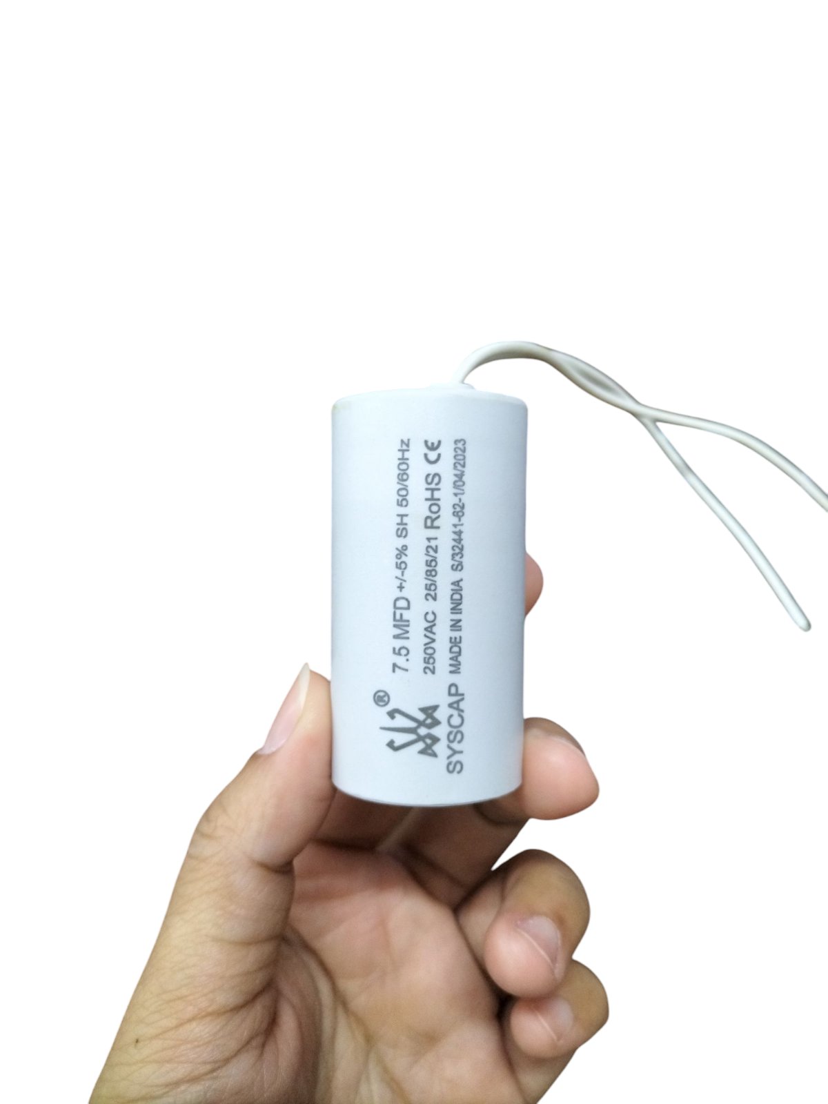 Syscap Capacitor 7.5MFD 250 VAC held in hand with white casing and attached wires