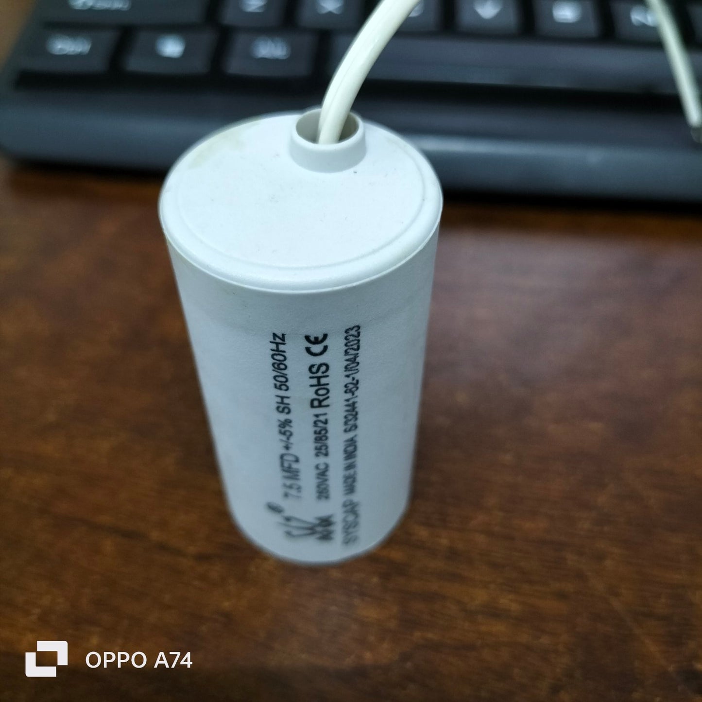 Syscap Capacitor 7.5MFD 250 VAC white cylindrical electrical component with wires