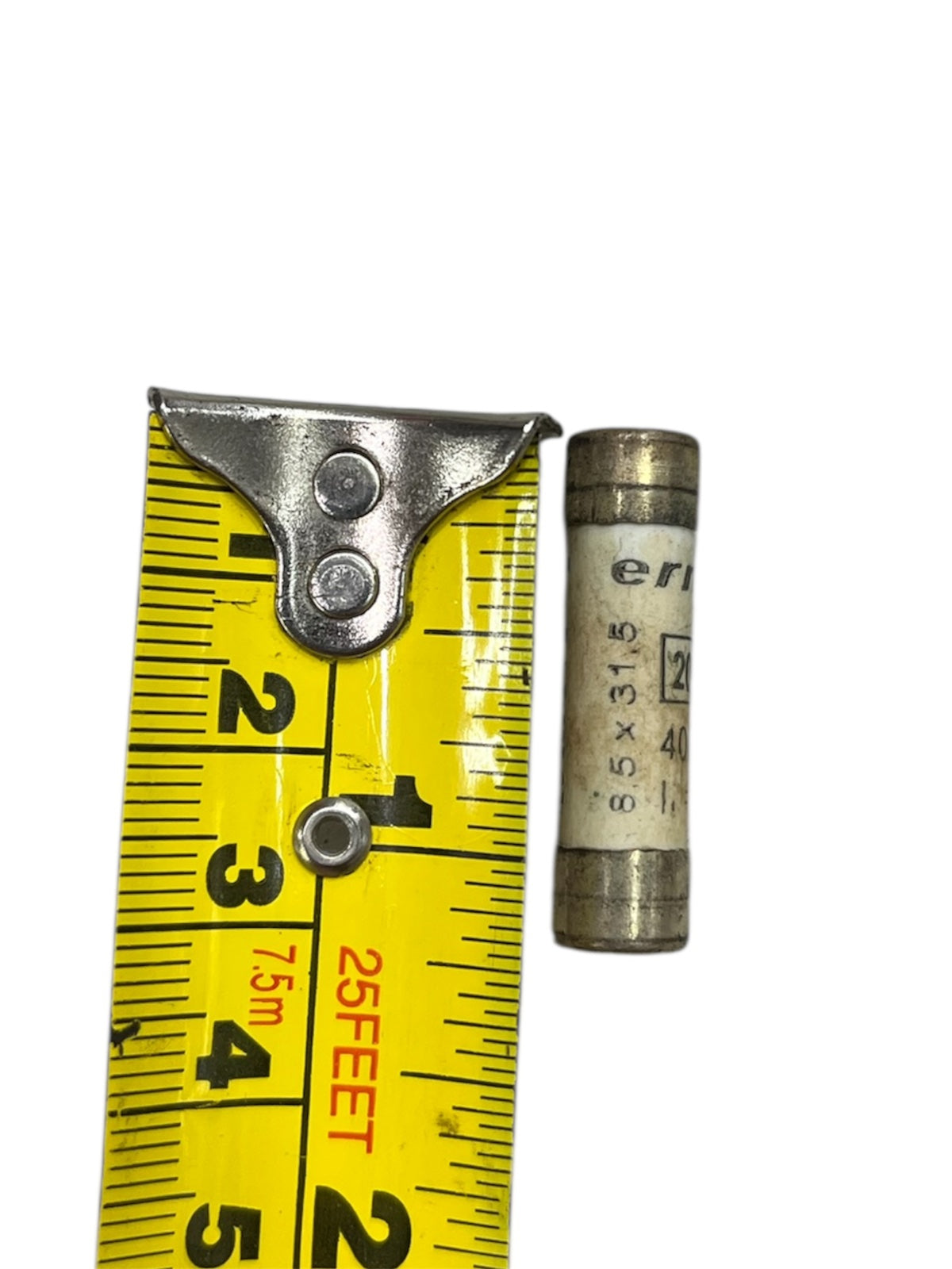 Ceramic Fuse 20A 400v 8x31mm electrical component next to yellow measuring tape