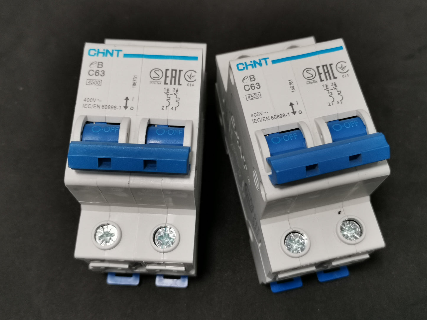 Chint 63A 2 pole miniature circuit breaker electrical component with blue switches on black background