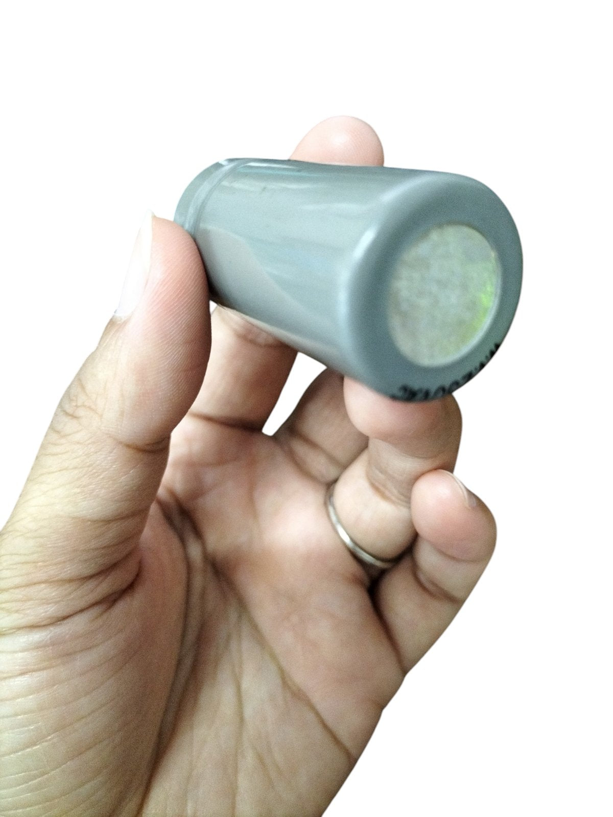 Hand holding a gray 0.5MFD Motor Running Capacitor from DRE for electrical circuitry and parts