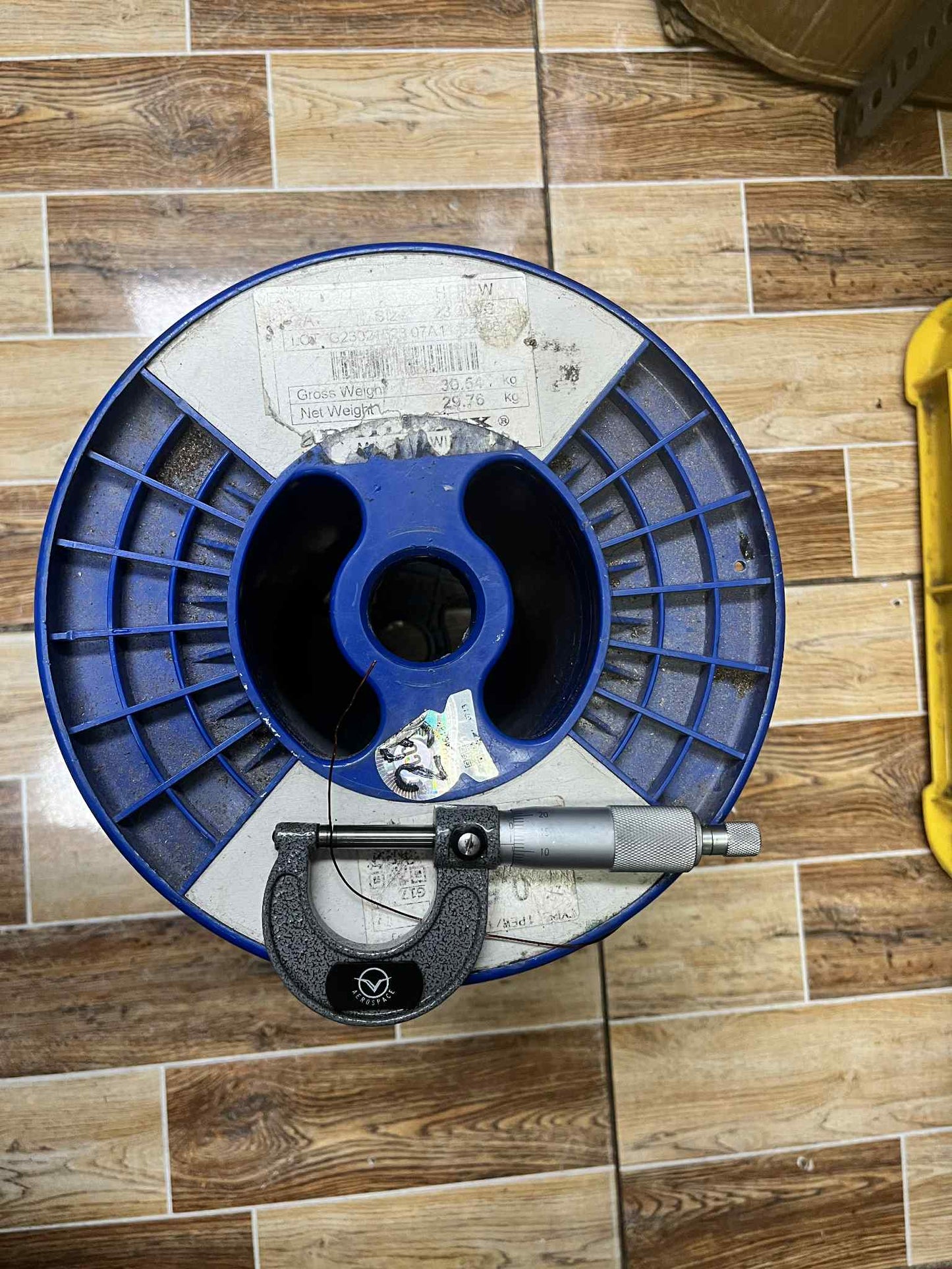 Philflex Heavy Formix magnet wire AWG 23 600G on a spool with measurement tool for precise usage