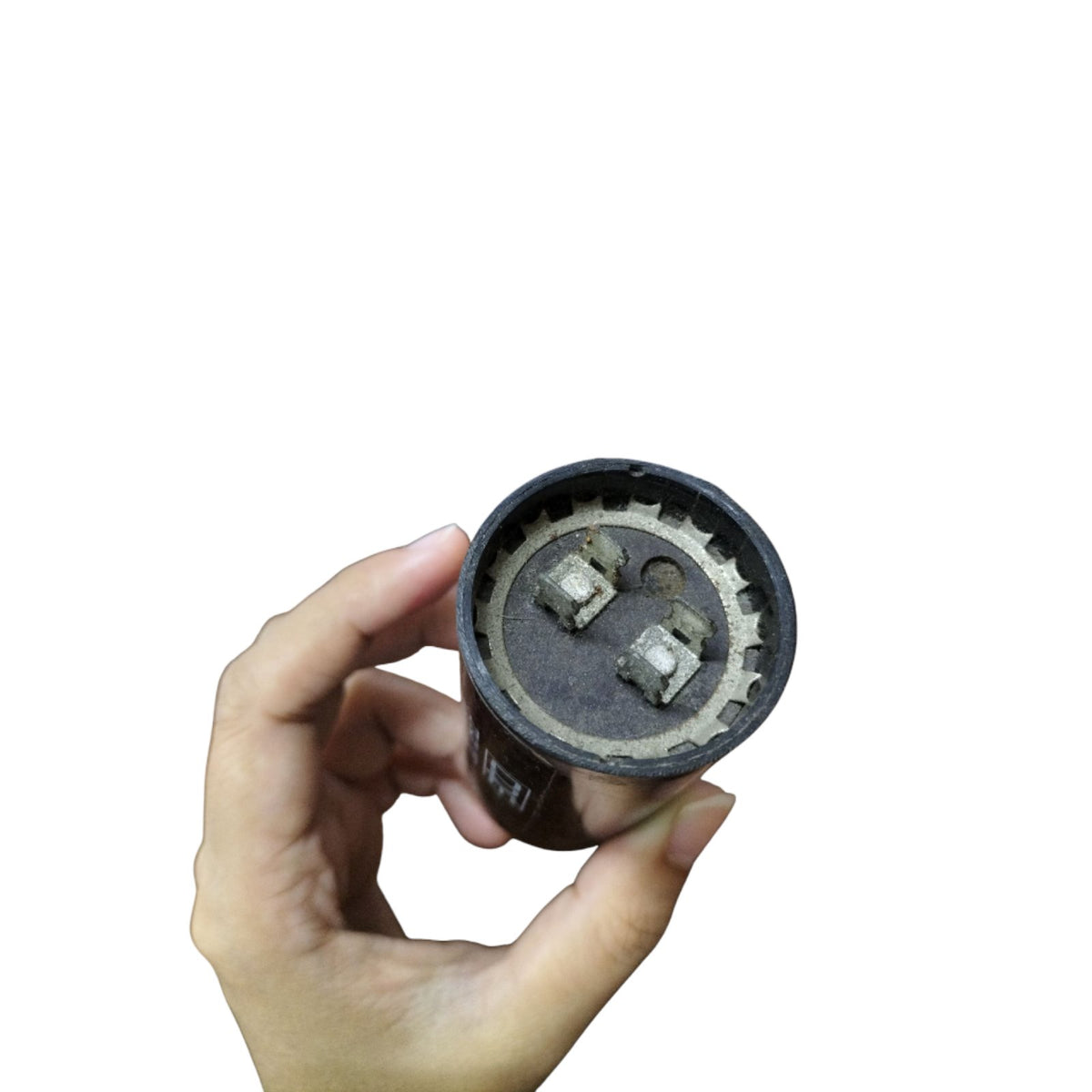 Mallory 216-259MFD 330V AC Capacitor held in hand, showcasing the terminals clearly.