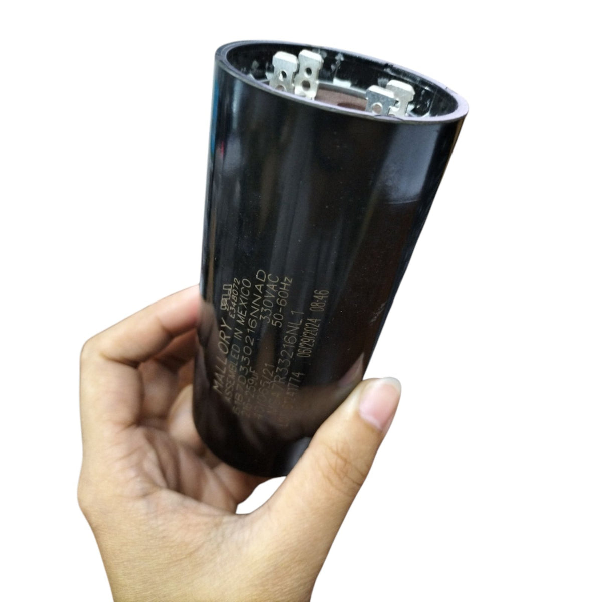 Mallory 216-259MFD 330V AC Capacitor in a hand showcasing its durable design and specifications