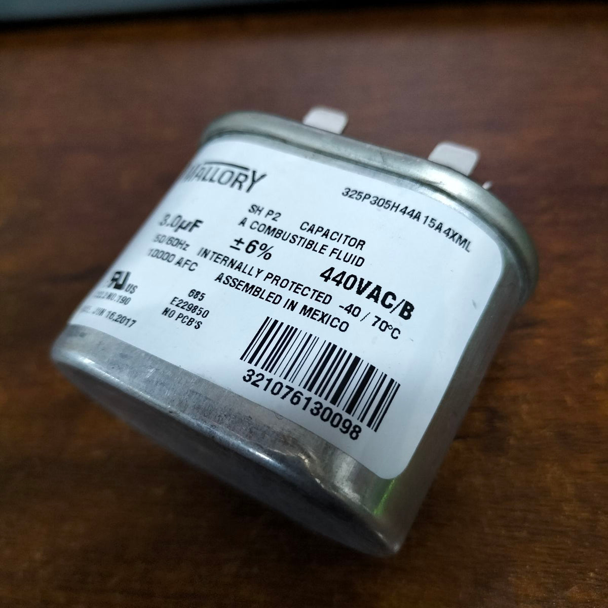 Mallory 3UF 440V oil-filled capacitor with compact design and durable metal housing.