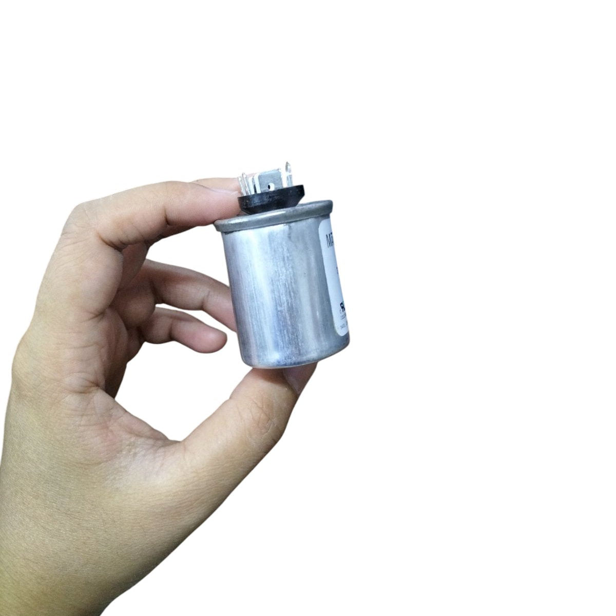 Hand holding a Mallory 3UF 440V oil-filled capacitor with silver casing for electrical applications