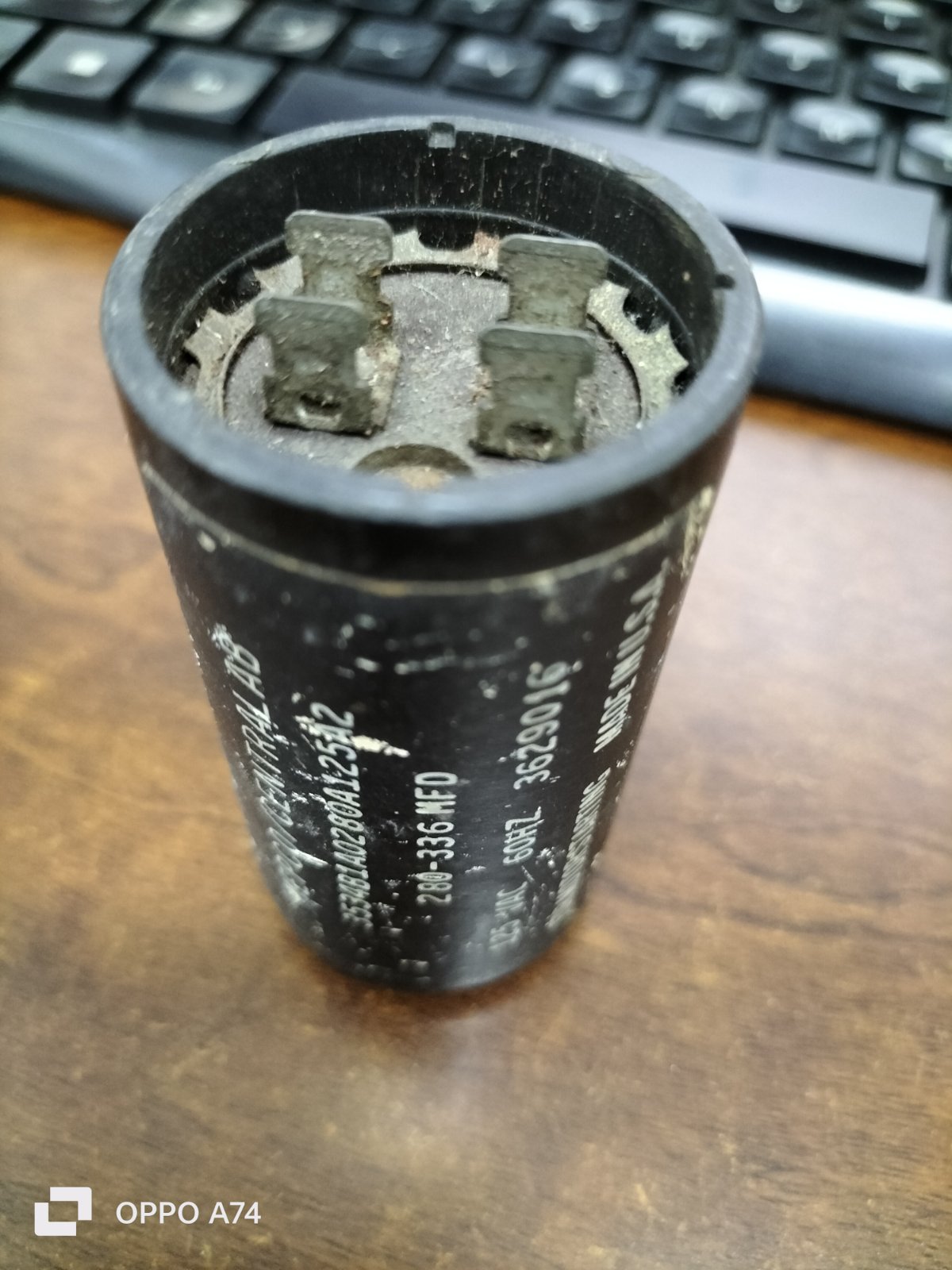 Motor starting capacitor 280-366 MFD black cylindrical electrical part with metal terminals