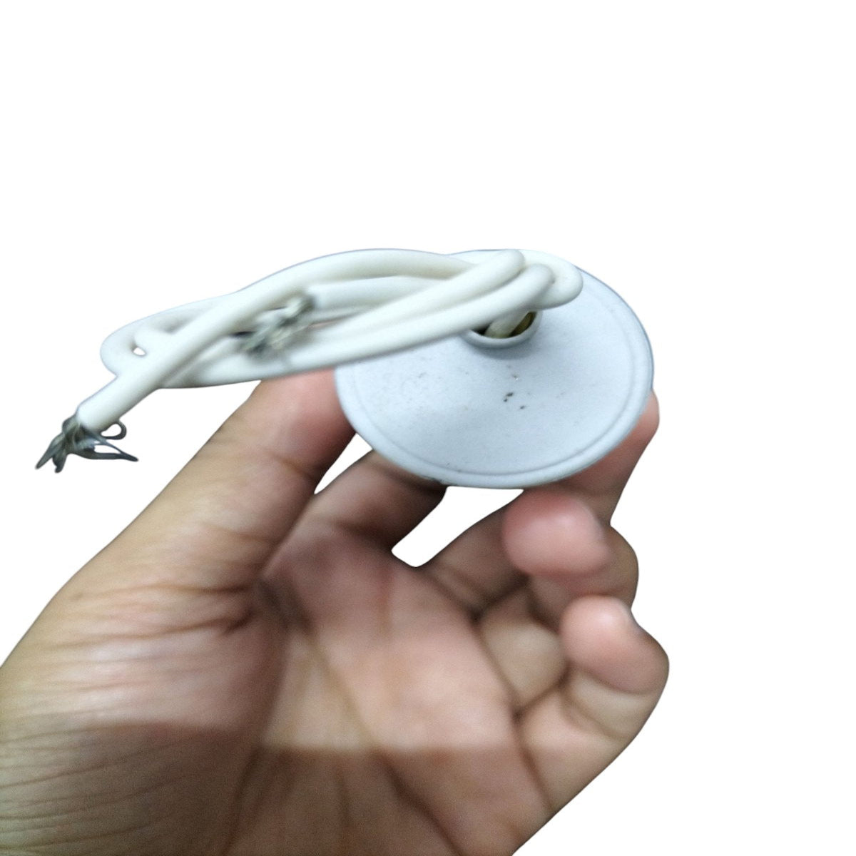 Hand holding a Syscap Motor Running Capacitor 250 VAC with attached wires and a round casing