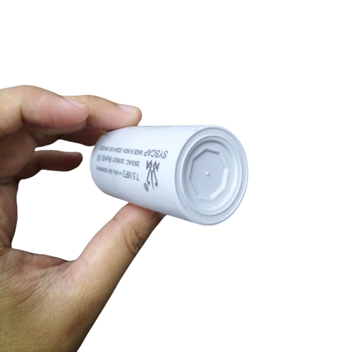 Syscap Motor Running Capacitor 250 VAC held in hand for electrical circuit applications