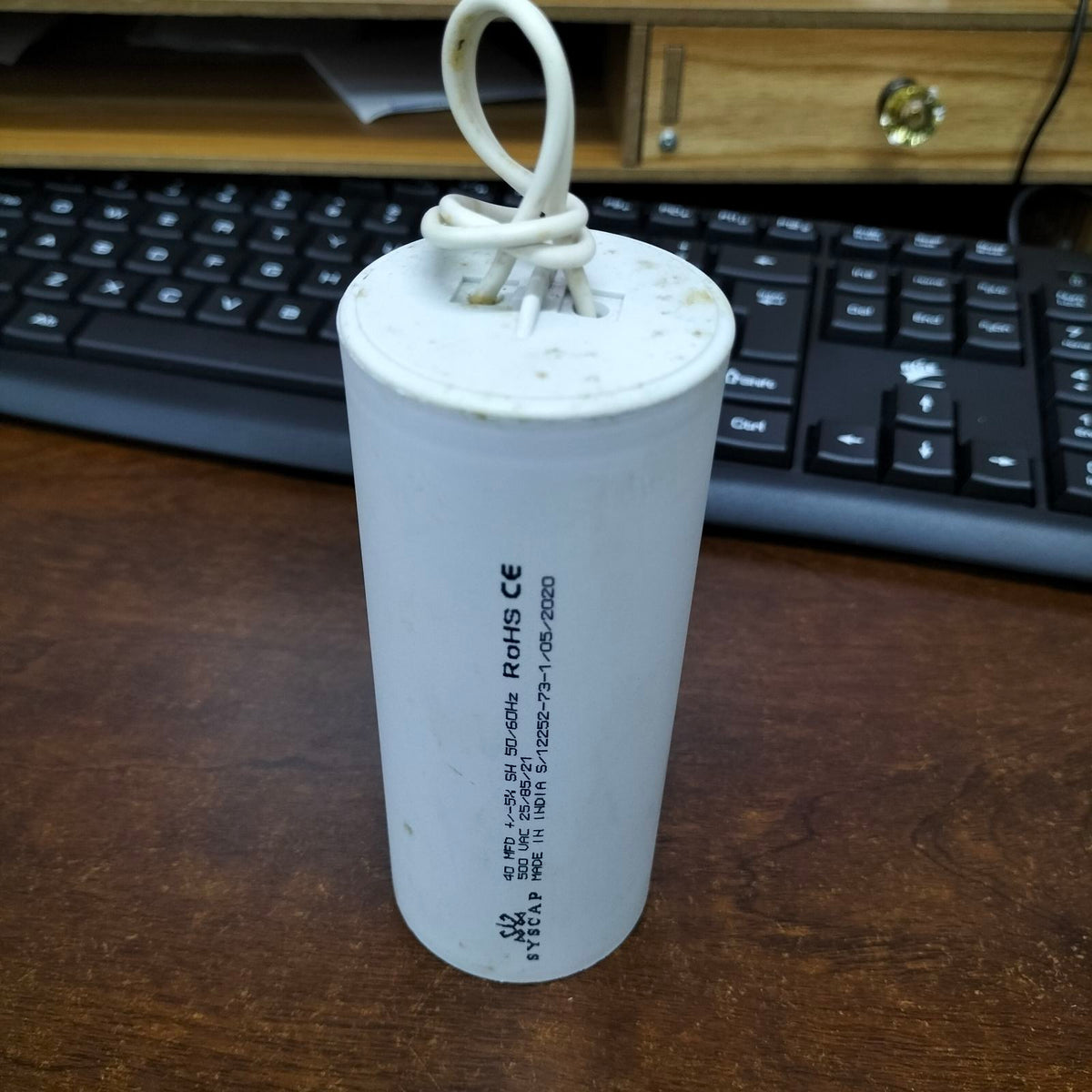 SYSCAP motor running capacitor 40uF 500V with a white cylindrical body for reliable motor performance