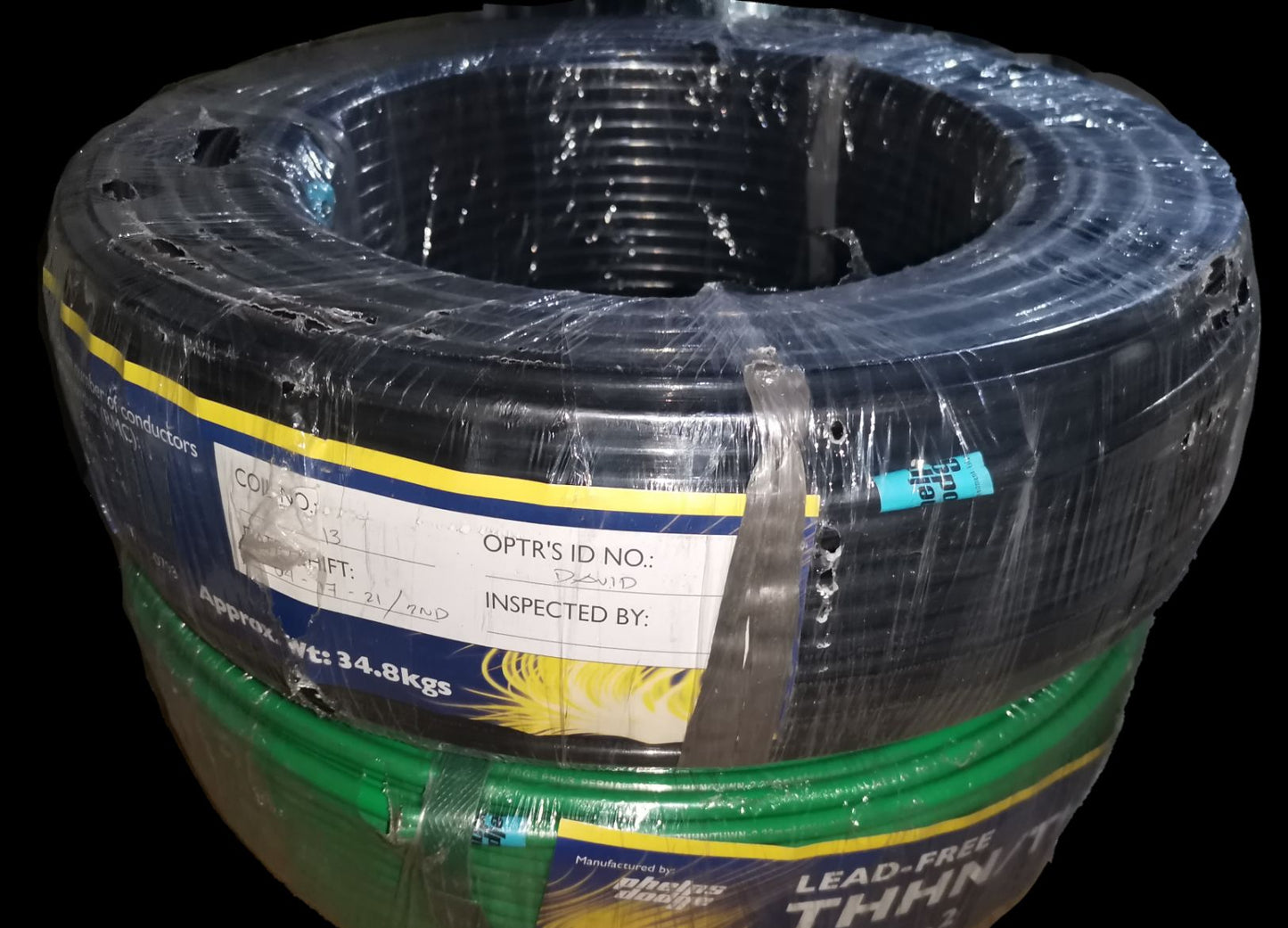 Coiled pack of Phelps Dodge THHN Wire 30mm in black and green insulation wrapped for electrical use