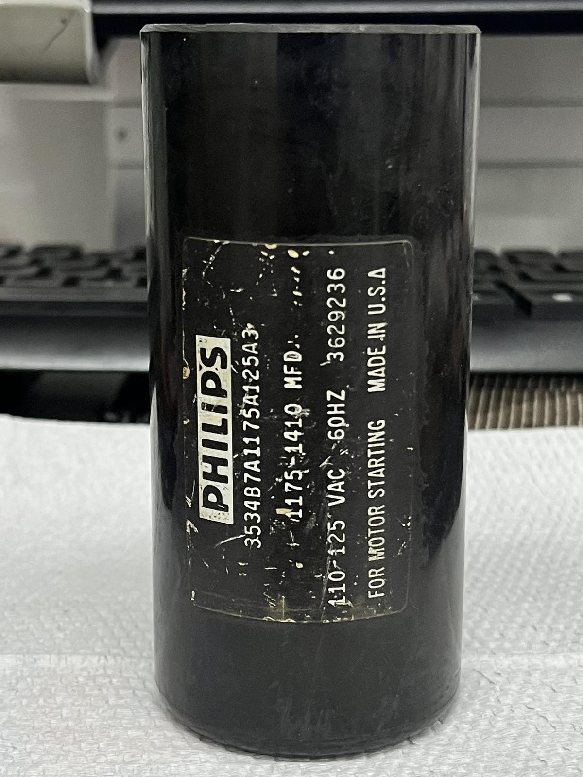Philips 1175-1410MFD motor start capacitor in black cylindrical casing for electrical circuitry