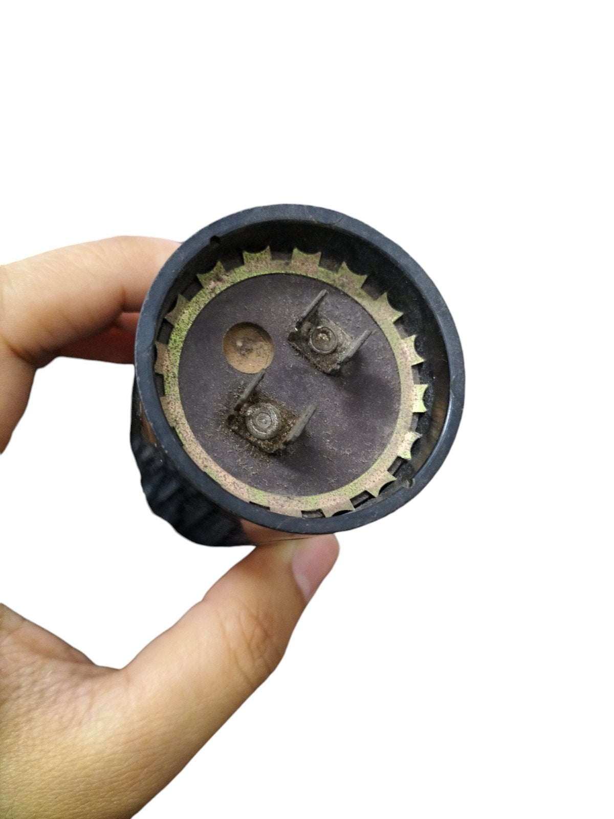 Close-up of BMI Motor Starting Capacitor 324-389 MFD showing terminals held in hand