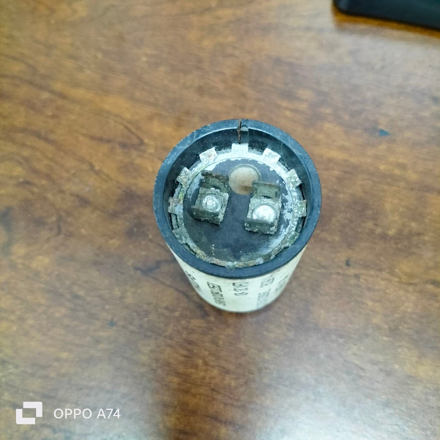 Philips Starting Capacitor 108-130 MFD electrical component on a wooden surface