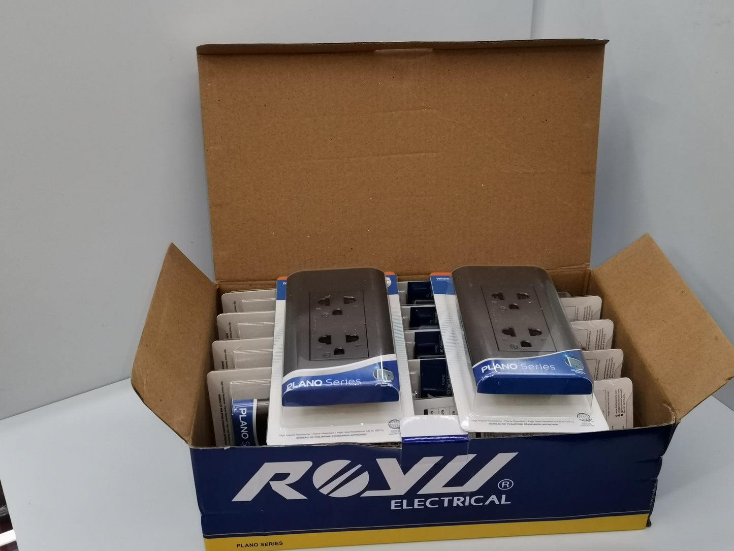 Royu Universal Outlet 15A 250V Dark Gray packaged in blue and yellow box for electrical power points