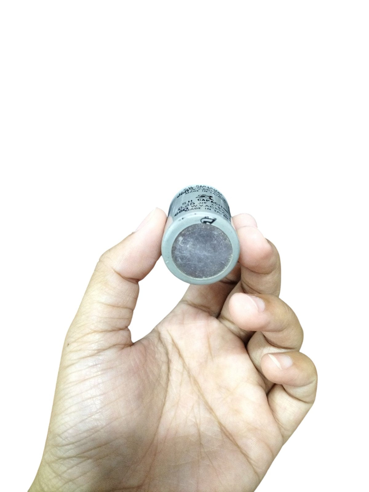 Hand holding SH Motor Running Capacitor 0.25UF 660V AC electrical component for motors
