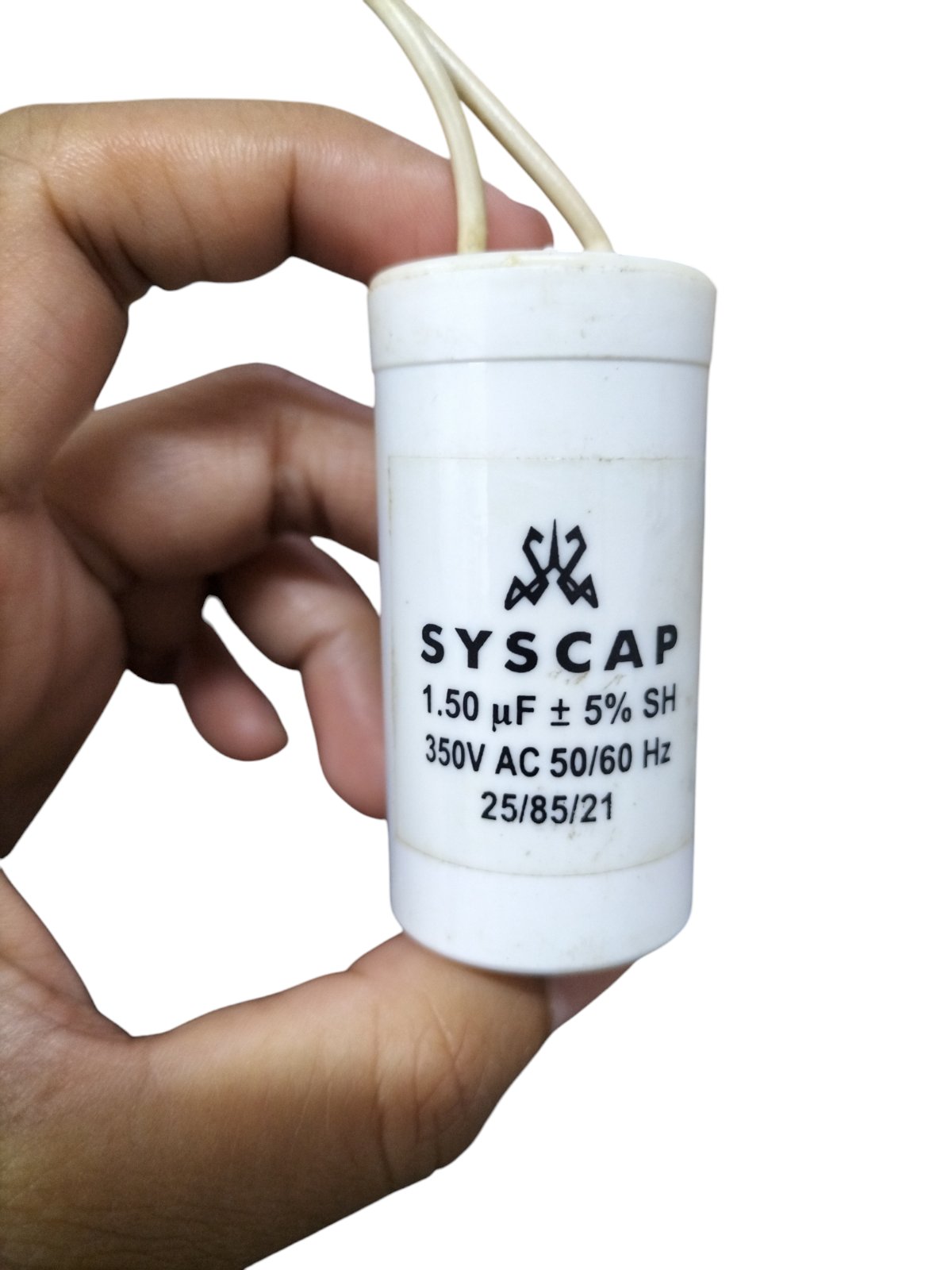 Hand holding a SYSCAP 1.5 microfarad capacitor white cylindrical electrical component