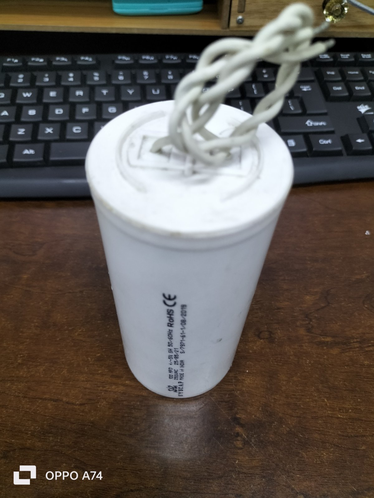 SYSCAP 100MFD 250V AC Motor Running capacitor white cylindrical electrical part with wires on wooden desk