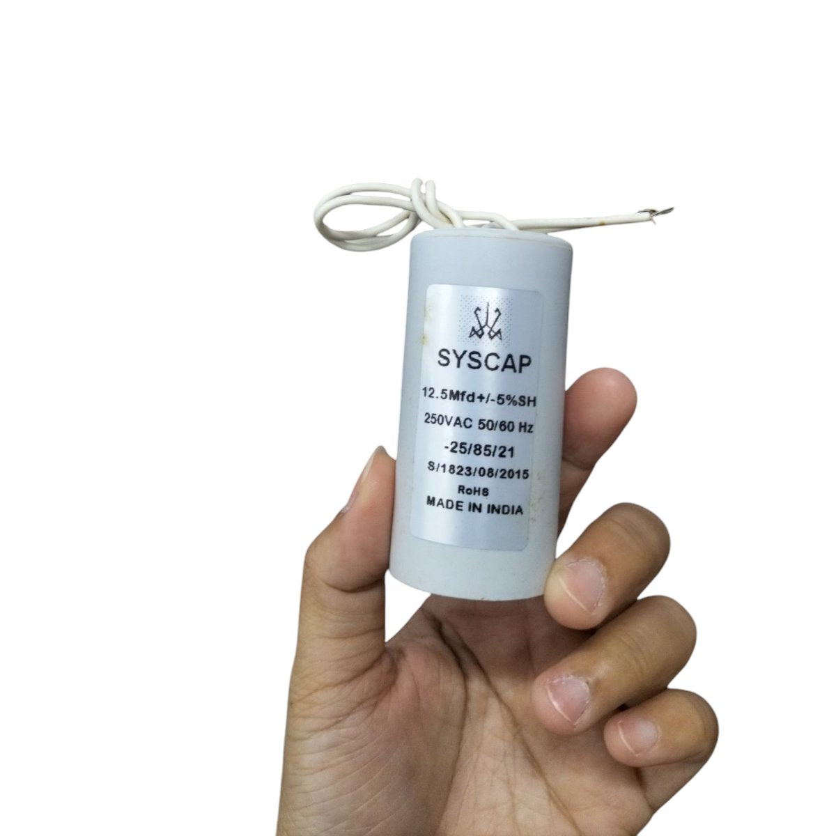 Syscap 250 VAC Running Capacitor in hand, designed for electrical circuitry applications