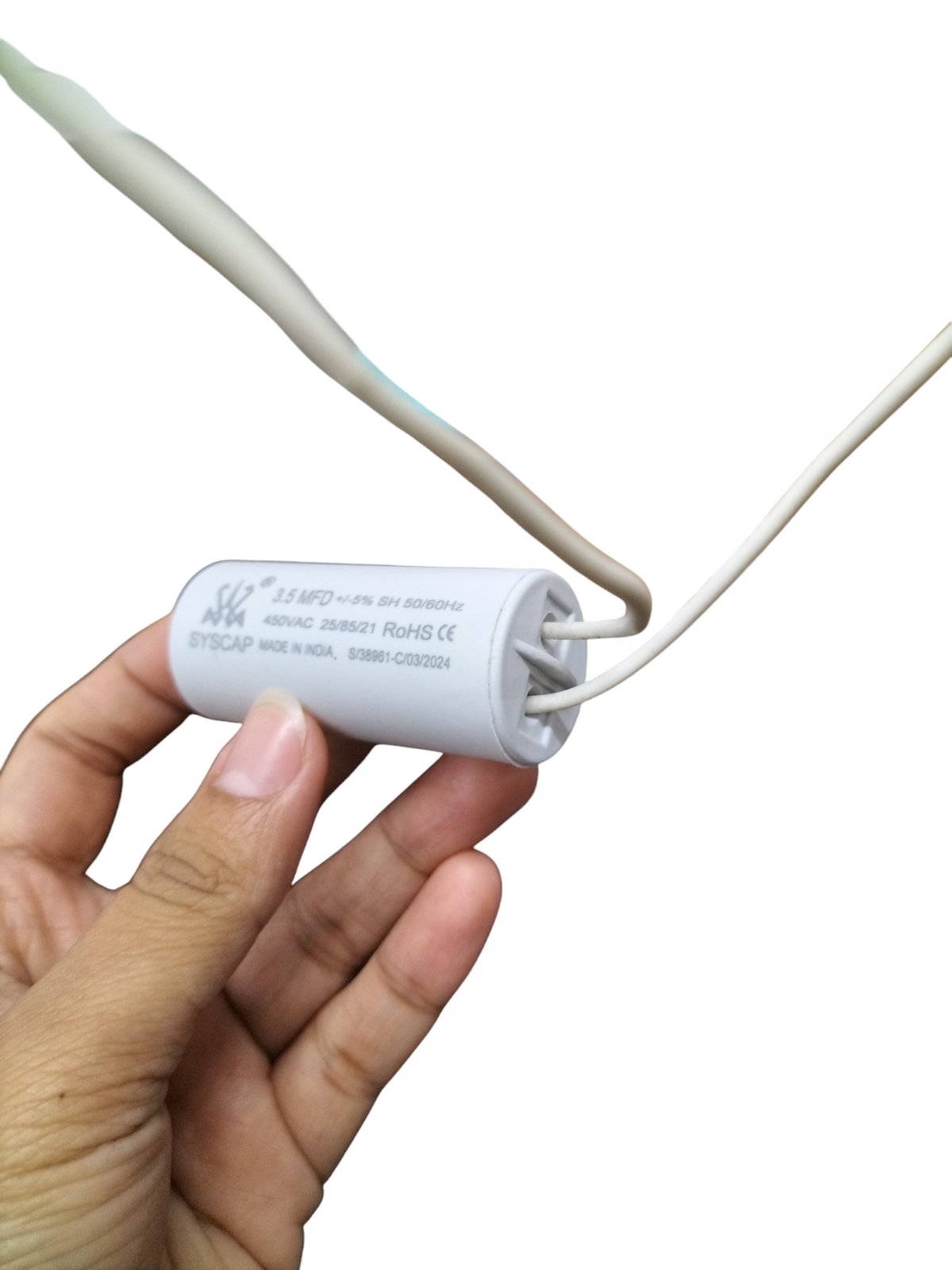 Syscap 3.5MFD 450V AC Running Capacitor held in hand with white electrical wires attached