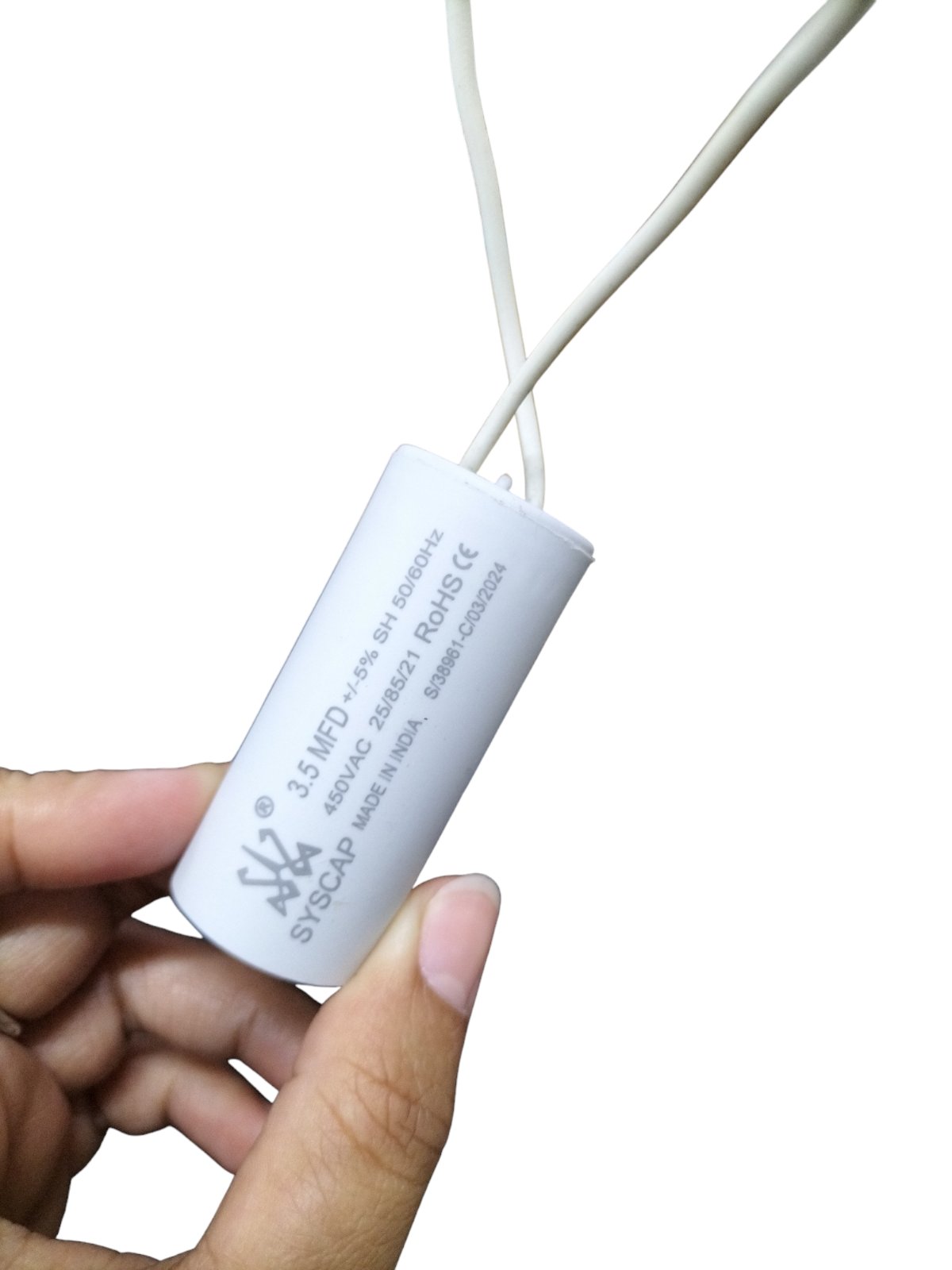 Syscap 3.5MFD 450V AC Running Capacitor held between fingers with white wires attached