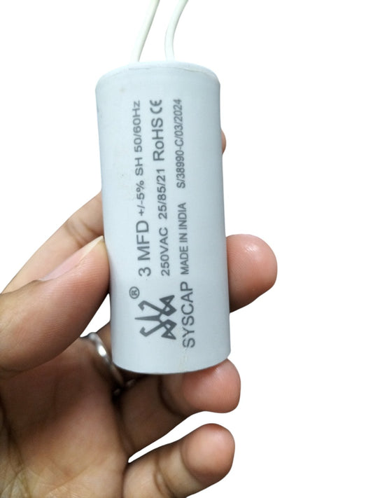 Syscap 3MFD 250 VAC Running Capacitor for electrical circuitry held in hand with white wires