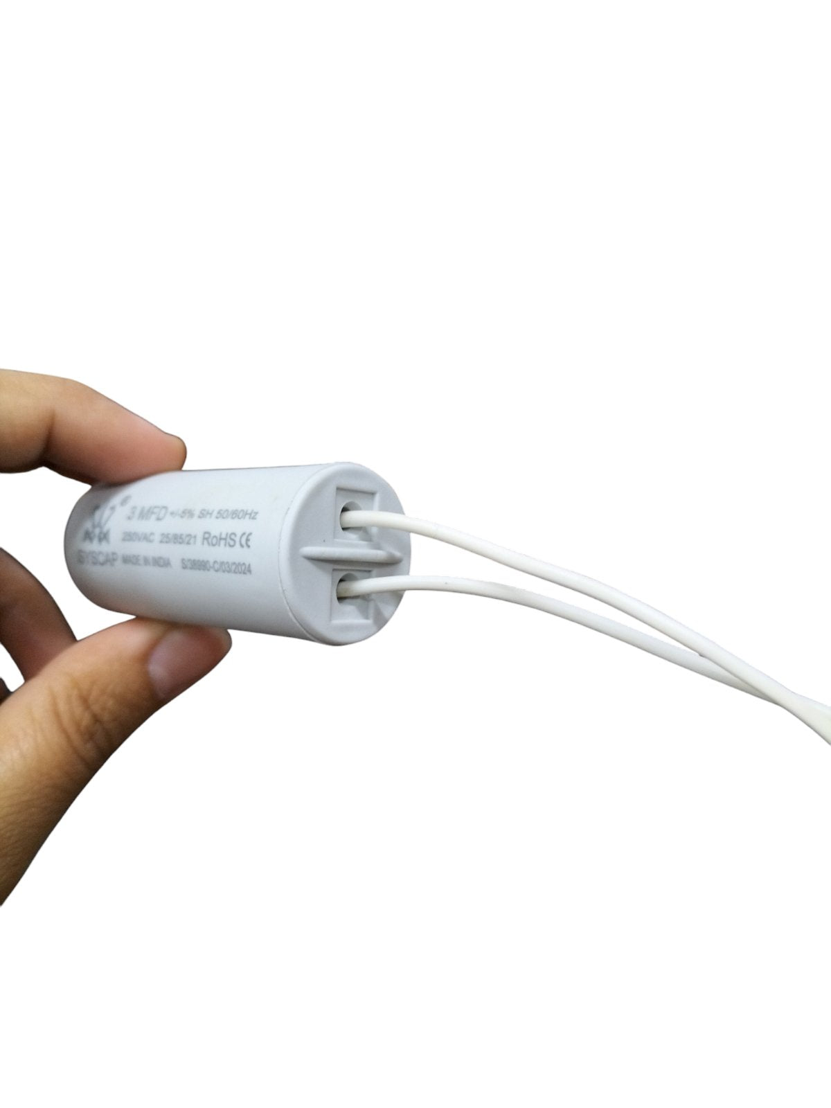 Syscap 3MFD 250 VAC Running Capacitor with white wires held in hand for electrical circuitry
