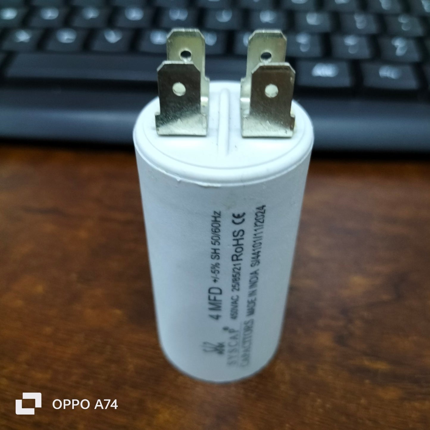 Syscap 4MFD motor running capacitor with metal terminals on white cylindrical body