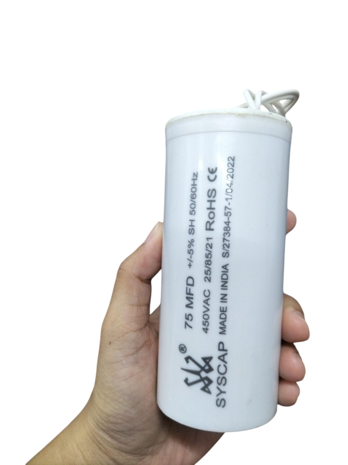 SYSCAP 75MFD motor capacitor 450V AC held in hand for electrical circuitry applications