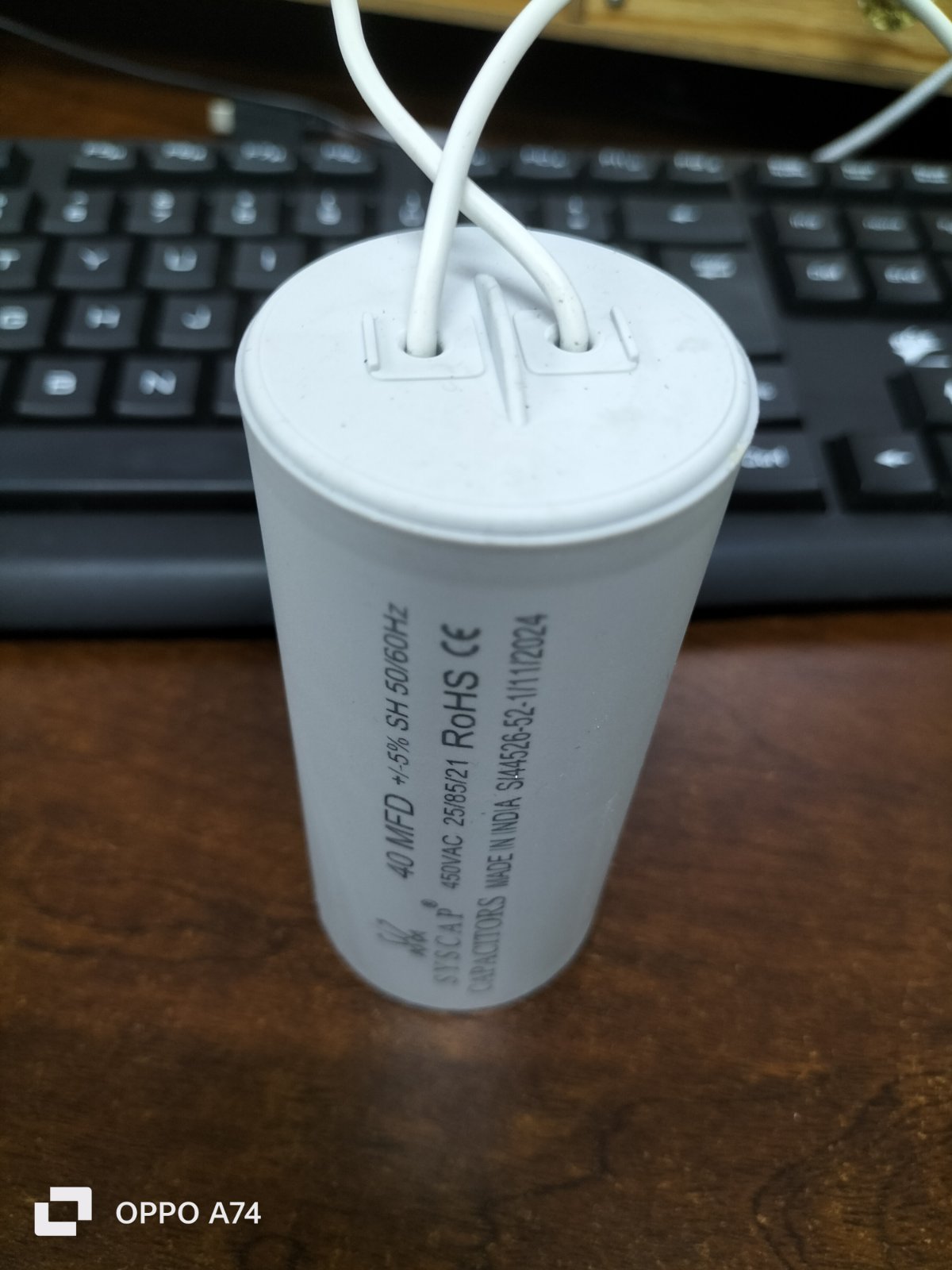 Syscap motor capacitor with white wires standing